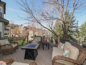 Wooden deck featuring an outdoor living space with a fire pit