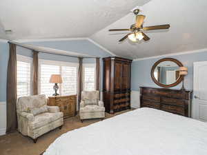 Bedroom featuring crown molding, carpet, lofted ceiling, and visible vents