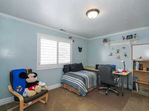 Bedroom featuring carpet flooring, ornamental molding, and baseboards