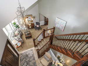 Stairs with a high ceiling and a chandelier