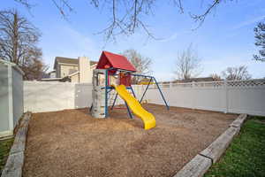 View of play area with a fenced backyard