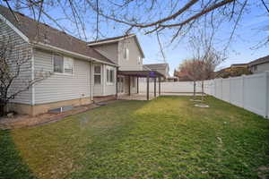 View of yard with a fenced backyard and a patio area