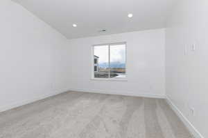 Spare room with baseboards, visible vents, recessed lighting, and light colored carpet