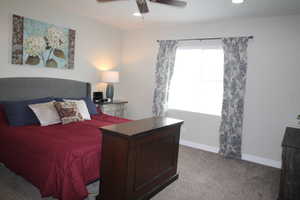 Master bedroom with curtains, recessed lighting, and a ceiling fan
