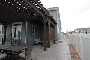 View of patio with a pergola, a gate, fence and patio