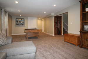 Interior space featuring carpet flooring, stairs, recessed lighting, and pool table