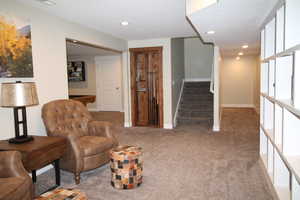 Sitting room with, carpet, stairway, and recessed lighting