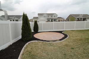 View of yard with a fenced backyard and a separate patio