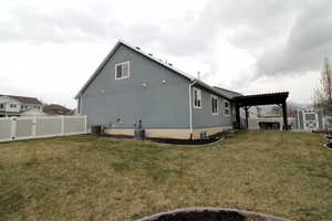 View of home's exterior featuring a fenced backyard, a lawn, cooling unit and mountain views.