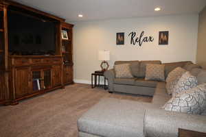 Carpeted living room featuring and recessed lighting