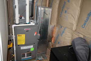 Utility room featuring heating unit
