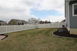 View of yard featuring central AC unit, and fenced backyard