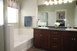 Master Bathroom featuring a separate shower, double vanity and garden tub