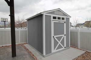 View of shed in fenced backyard