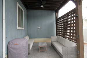 View of patio featuring an outdoor hangout area and a ceiling fan