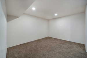 Carpeted spare room featuring recessed lighting