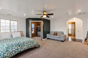Bedroom with recessed lighting, arched walkways, and visible vents