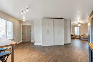 Interior space featuring baseboards, a ceiling fan, and wood finished floors