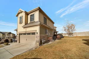 View of home's exterior featuring stone siding, concrete driveway, fence, central AC unit, and a garage