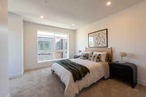 Carpeted bedroom with recessed lighting and baseboards