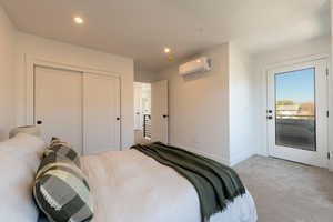 Carpeted bedroom featuring recessed lighting, access to outside, an AC wall unit, and a closet