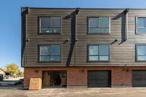 Rear view of house featuring brick siding