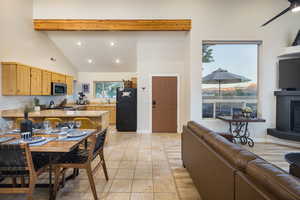 Kitchen with a sink, freestanding refrigerator, open floor plan, stainless steel microwave, and visible vents