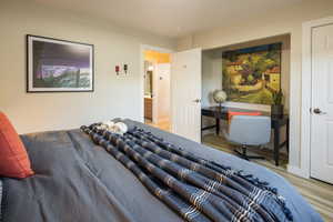 Bedroom with baseboards and wood finished floors