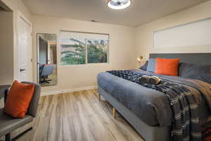 Bedroom featuring baseboards, visible vents, and light wood-type flooring