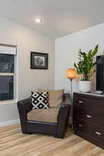 Sitting room featuring light wood finished floors and baseboards