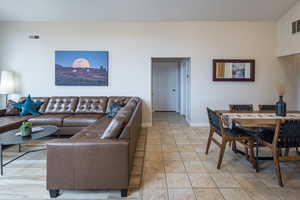 Living area with baseboards and visible vents
