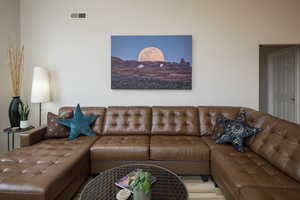 Living room with visible vents and wood finished floors