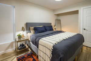 Bedroom with baseboards and wood finished floors