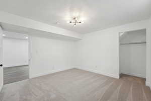 Unfurnished bedroom with recessed lighting, baseboards, a textured ceiling, carpet floors, and a closet