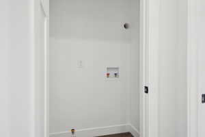 Washroom featuring baseboards, laundry area, and hookup for a washing machine