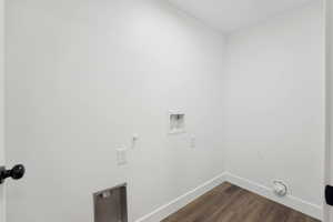Washroom featuring dark wood-style floors, baseboards, laundry area, and washer hookup