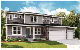 View of front of house featuring stone siding, a front yard, concrete driveway, and an attached garage