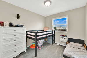 Bedroom with baseboards and carpet