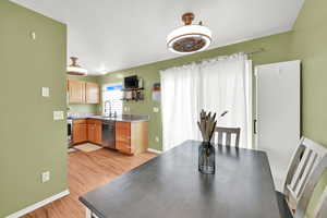 Dining area with baseboards and light wood-style floors