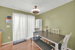 Dining space featuring light wood finished floors and baseboards