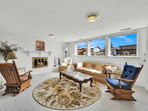Cozy living area with fireplace and windows for lots of sunlight