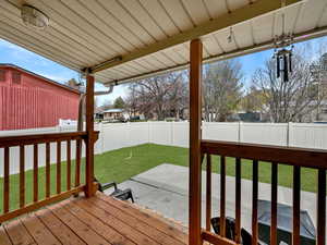 Deck featuring a new patio, and a fenced backyard