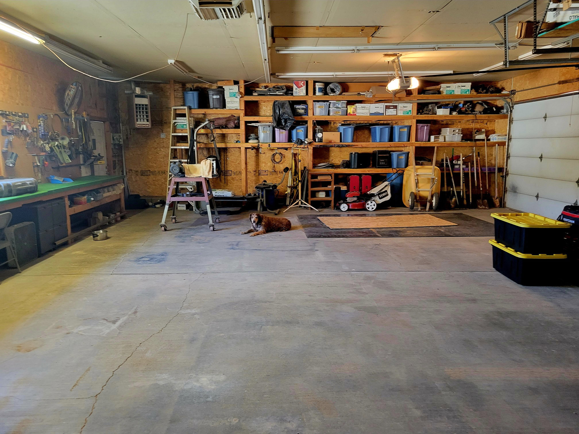 Garage with a workshop area and visible vents