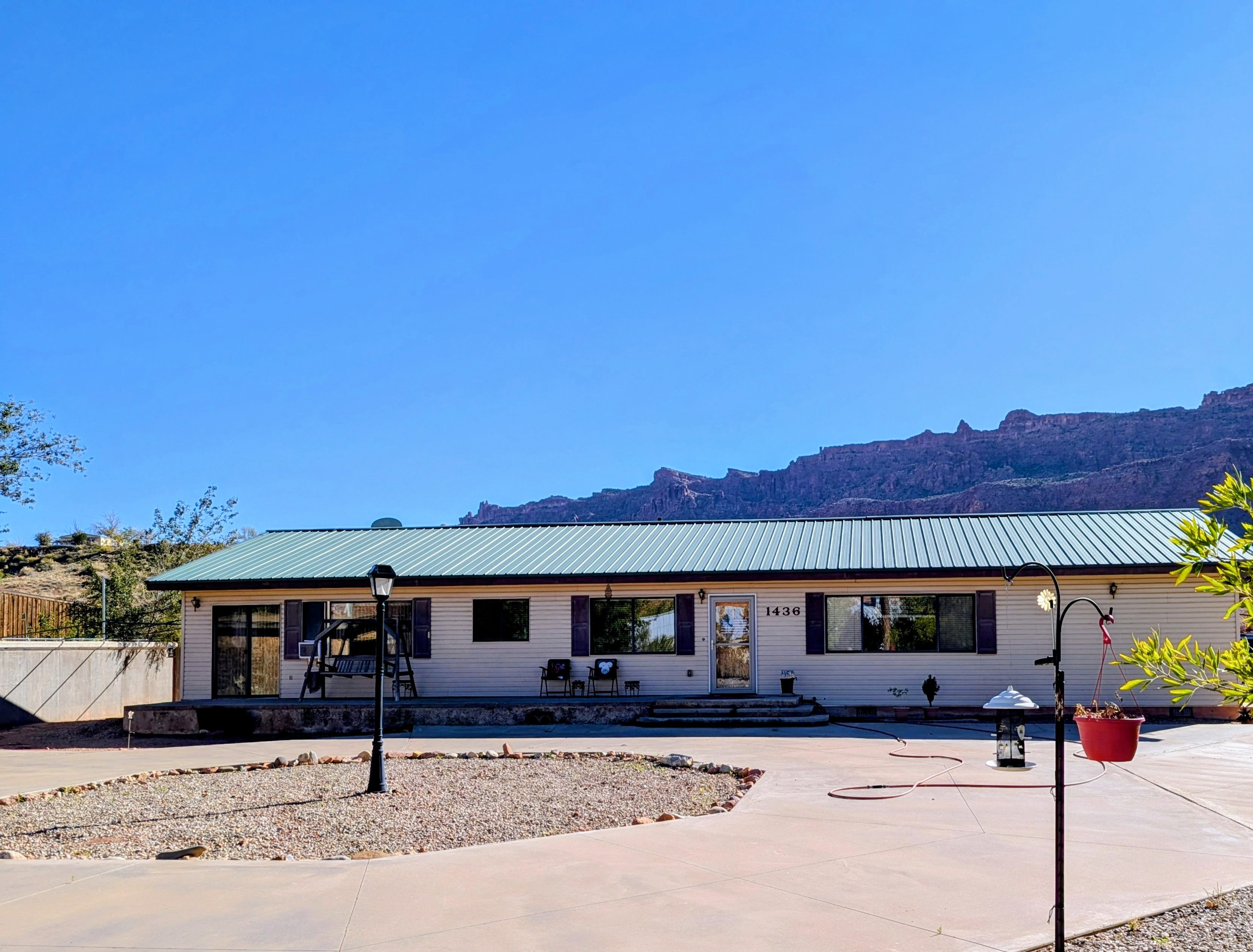 Single story home featuring a mountain view and a metal roof