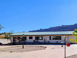 Single story home featuring a mountain view and a metal roof