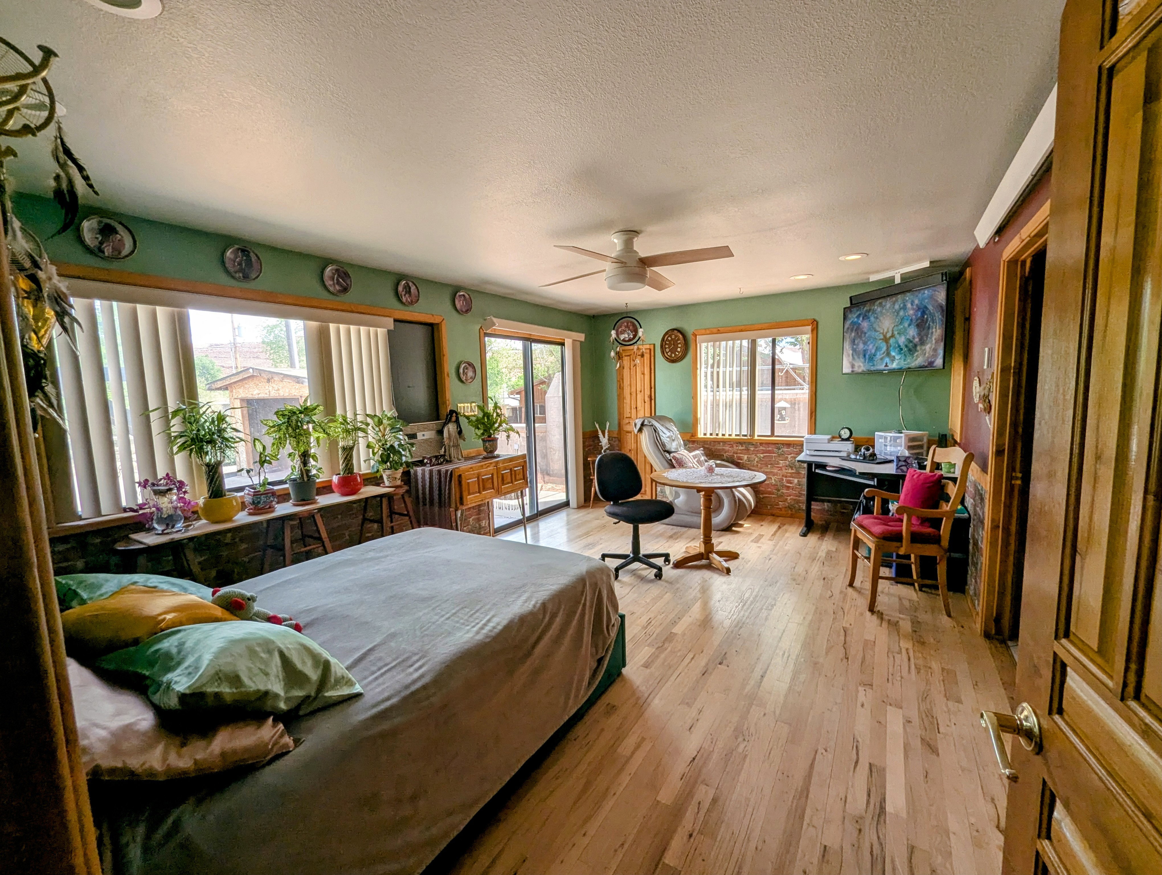 Bedroom featuring light wood-style flooring, a ceiling fan, a textured ceiling, and access to exterior