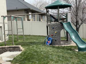 Community playground with fence and a lawn