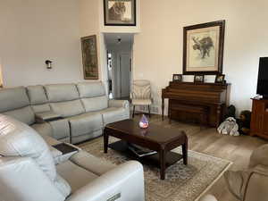 Living area featuring visible vents and wood finished floors
