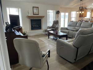 Living area with a tiled fireplace and light wood-style floors