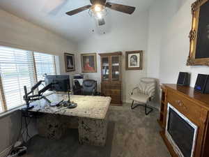 Office area with baseboards, lofted ceiling, a ceiling fan, and carpet